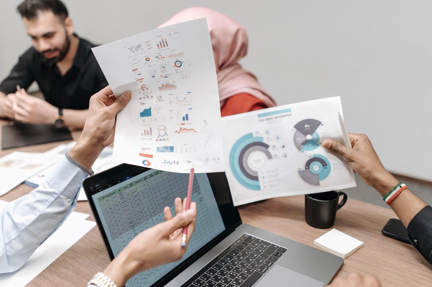 Colleagues reviewing business reports together