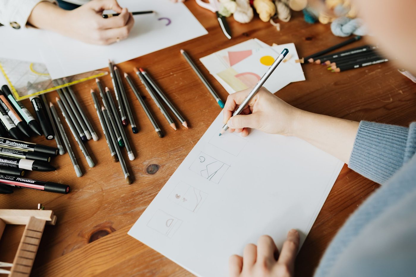 Designers sketching brand ideas on paper
